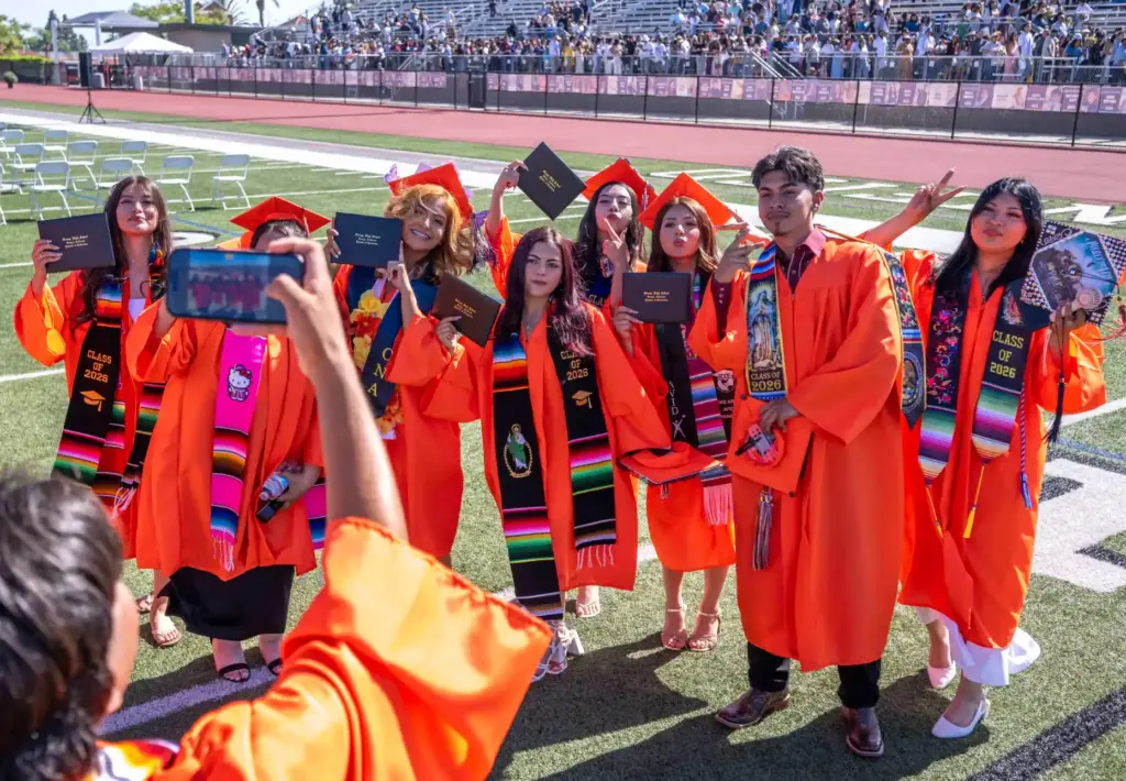 Orange High School graduates celebrate together following their graduation ceremony...