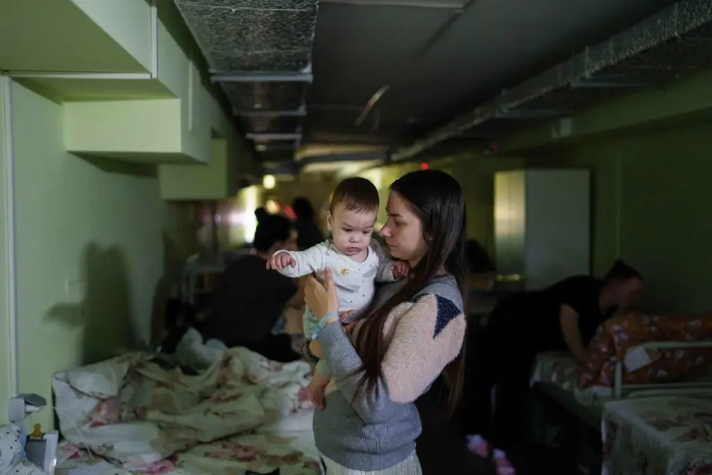 Marharyta Nekhoroshyva holds her son Mark inside a shelter at...