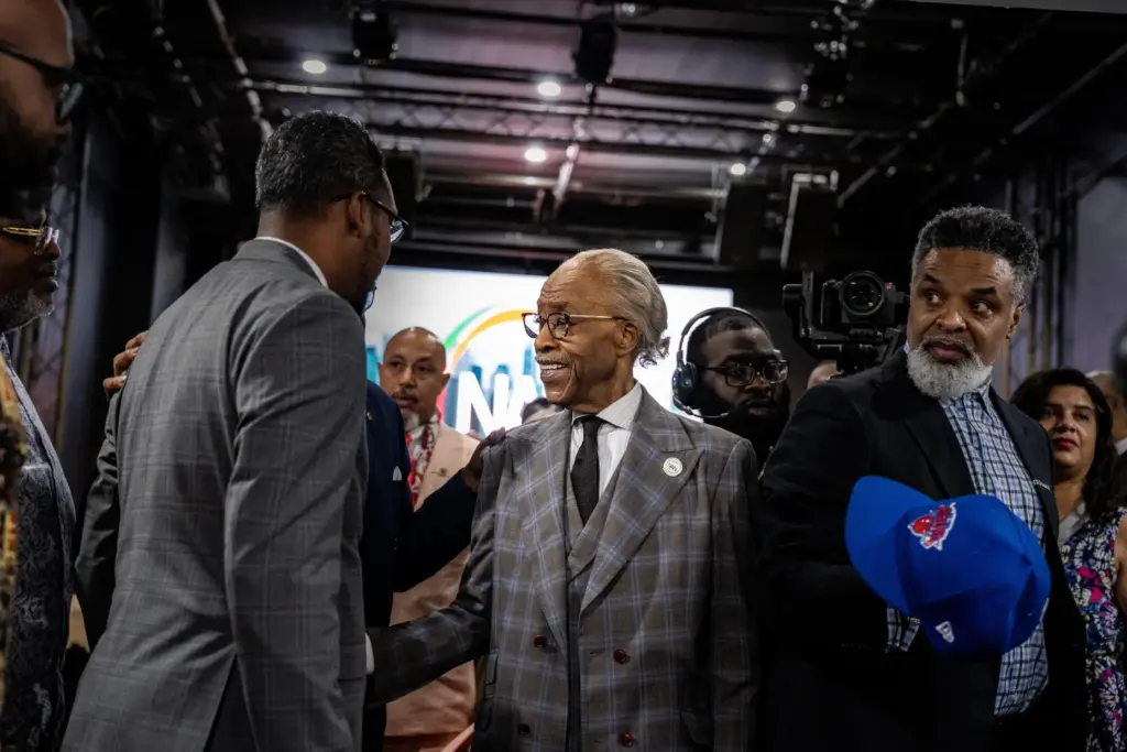 The Rev. Al Sharpton shakes hands with National Action Network board members and guests.