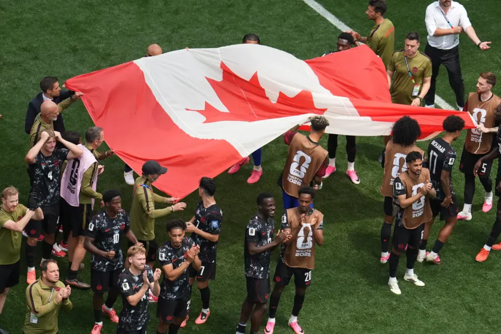 Players of Canada celebrate after the World Cup round of...