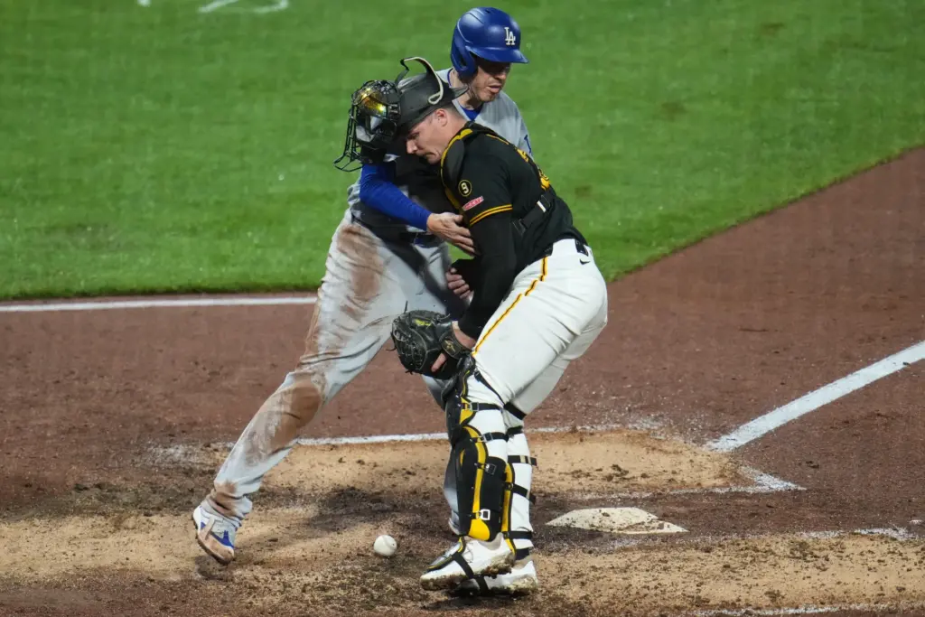 The Dodgers’ Freddie Freeman, top, scores from third base on...