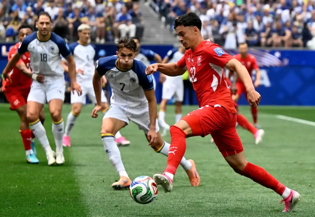 Switzerland midfielder Fabian Rieder (22) drives into the box as...