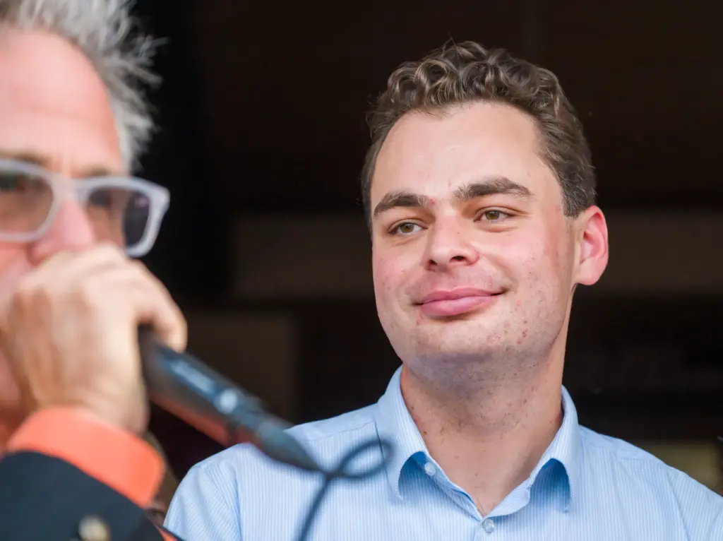 Laguna Beach City Councilmember Alex Rounaghi, right, listens to KXFM...