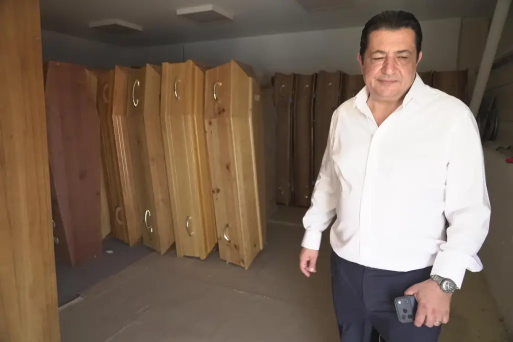 Zouhaeir Hertelli, a mortuary and funeral service director, walks out of his coffin storeroom.