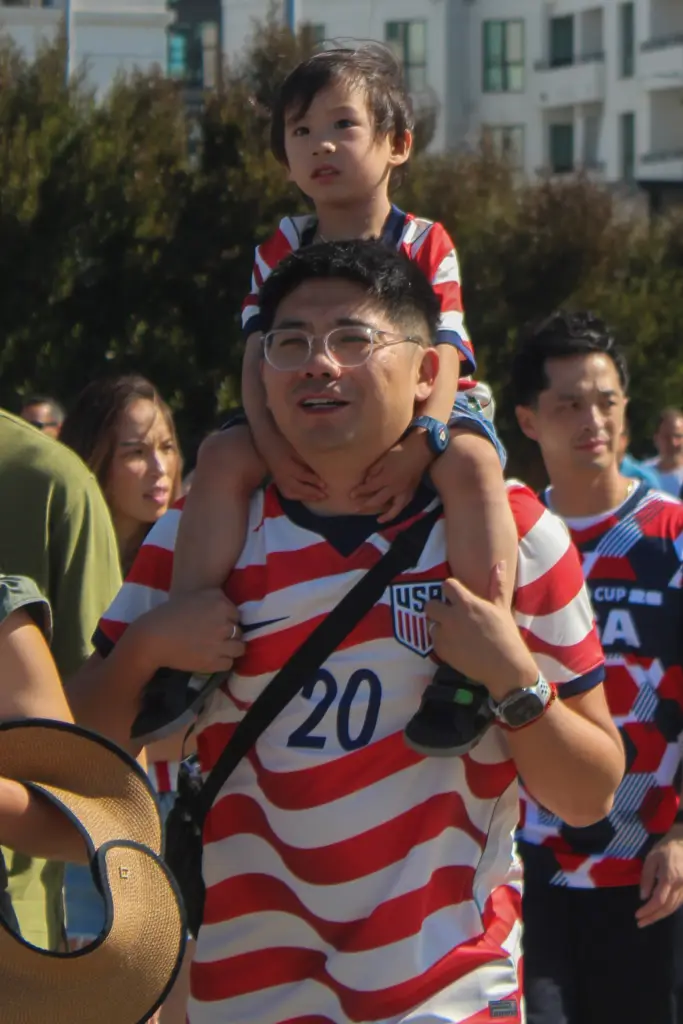 A son on his father’s shoulders as they made their...