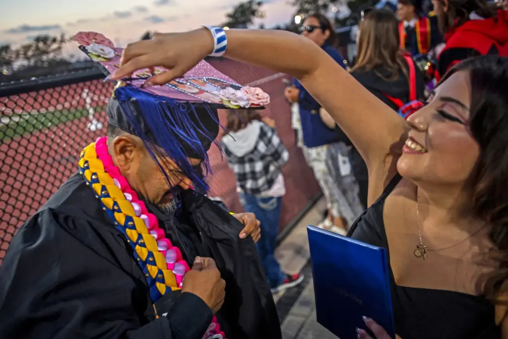 Fabiola Cosme dressed her father, Crescencio Cosme in her cap...