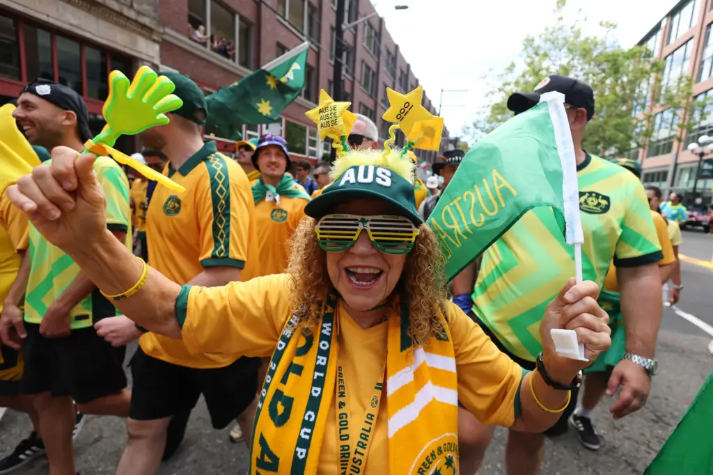 An Australian fan celebrates as fans march to the match...