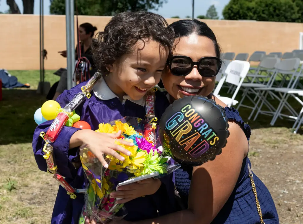 Liam Espinoza is congratulated by his aunt Ana Espinoza after...
