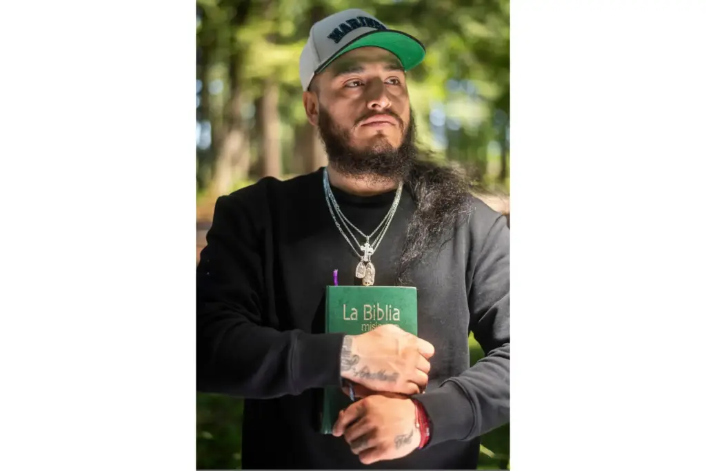 Gabriel Martinez Garcia, 30, holds a Bible close to his chest.