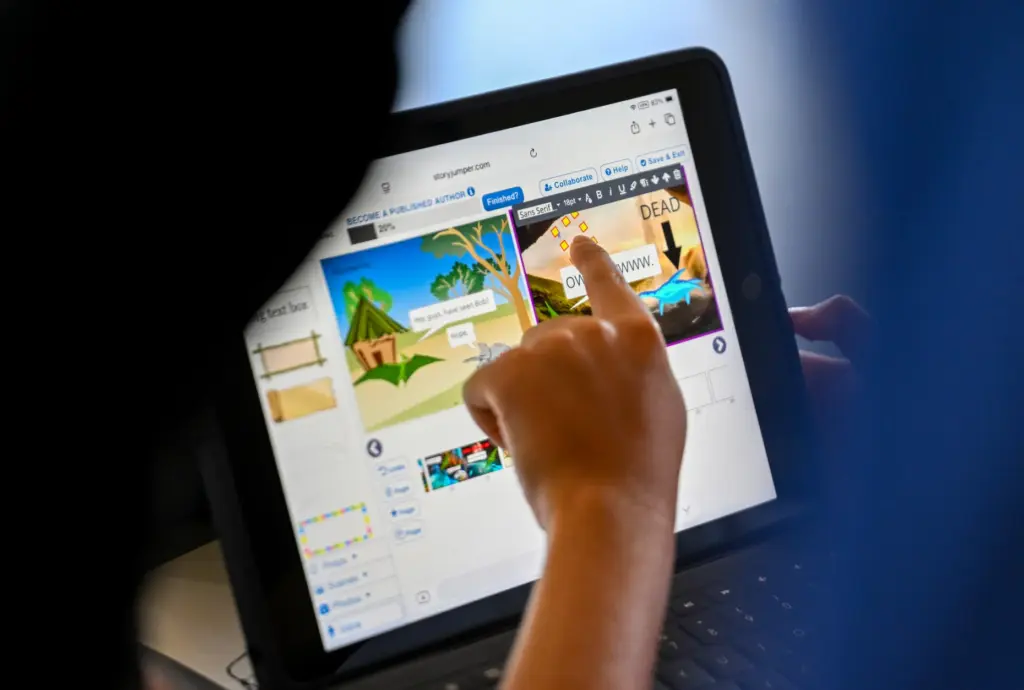 Tyler Pobiner works on artwork during âPublish Your Own Childrenâs...