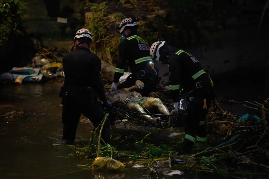 Police officers carry the body of Jose Perez from the...