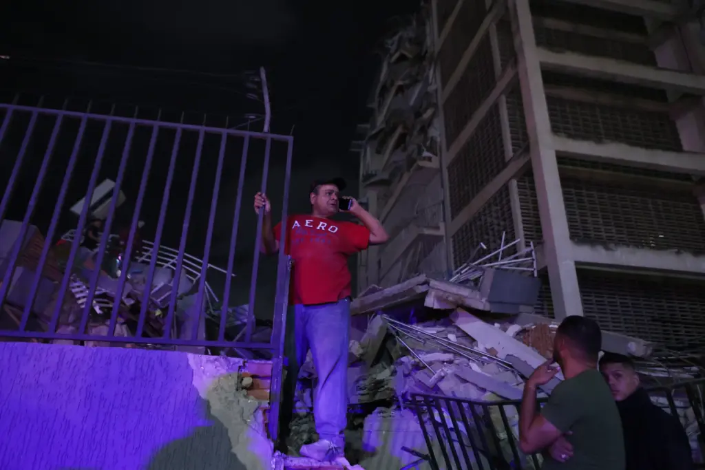 A man tries to make a call after an earthquake...