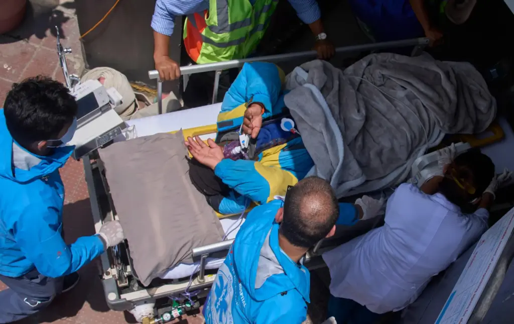 Medics take Dawa Sherpa, a mountain guide who had been...