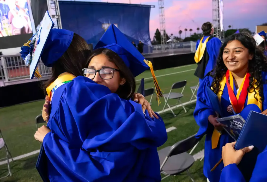 Graduates congratulate each other following the Valencia High School graduation...