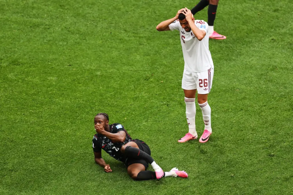 Qatar’s Mohamed Manai (26) reacts after Canada’s Ismael Kone (8)...
