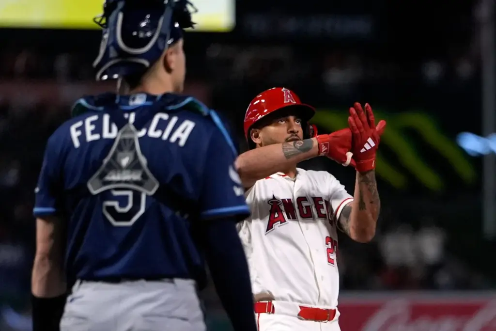 Angels’ Jose Siri, right, gestures as he scores after hitting...