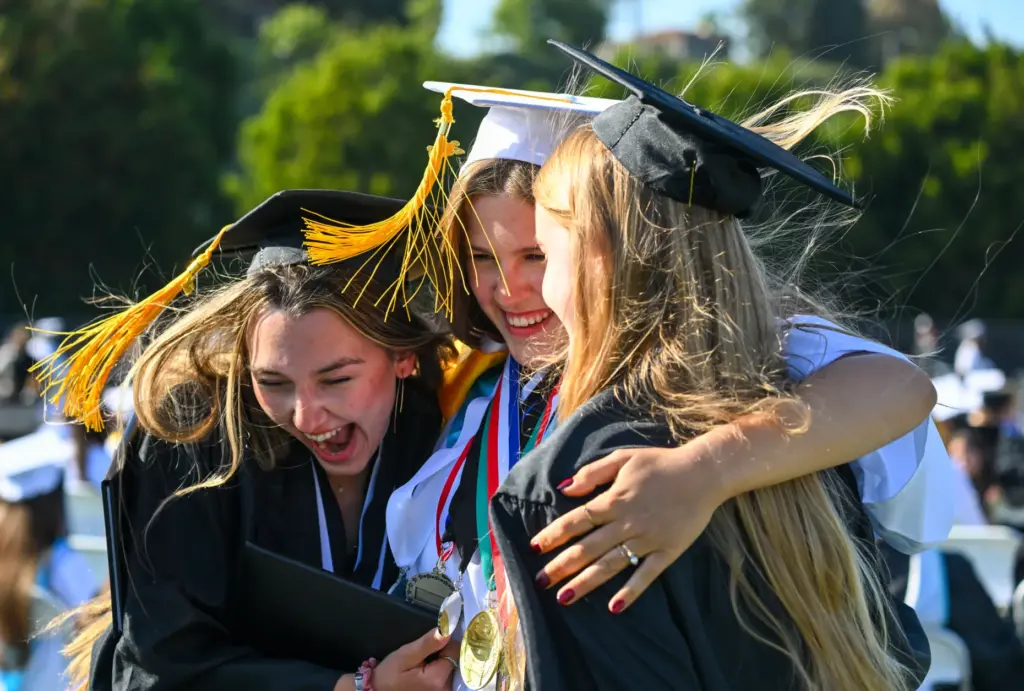 Graduates Melisa Kovacheva, left, Rachael Ryan, center, and Jillian Fiske...
