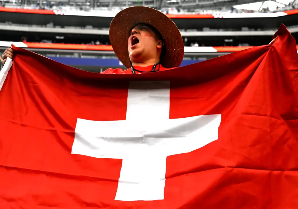 A Switzerland fan cheers during pregame activities prior to playing...