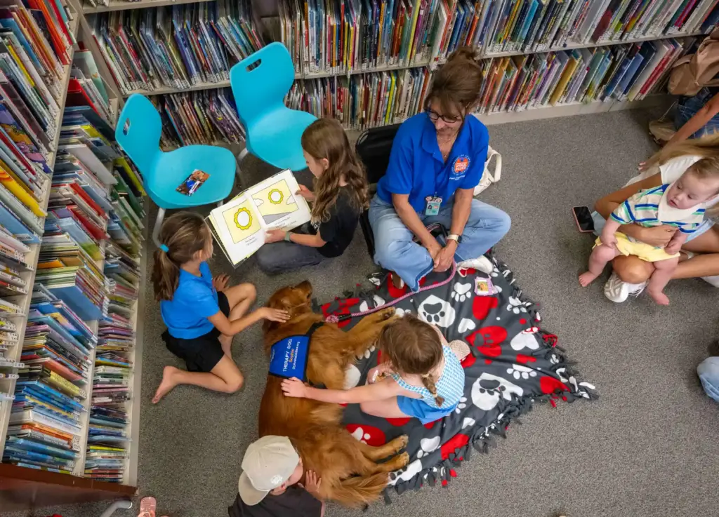 Kids read childrenâs books and give love to Sophie, a...