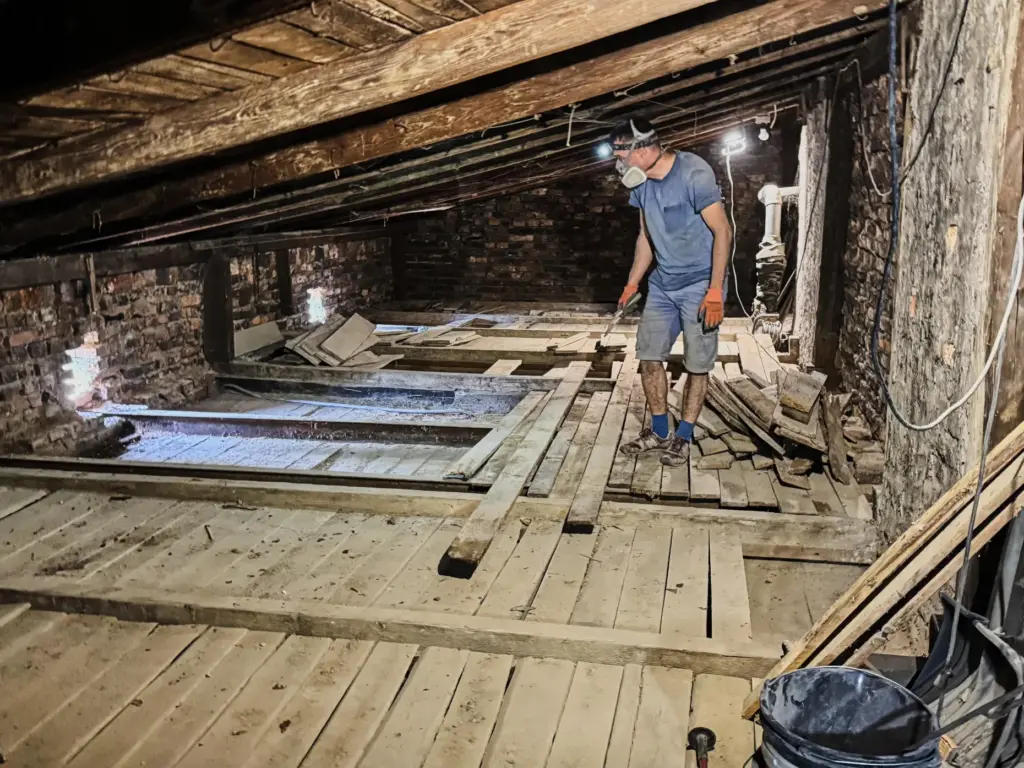 Wojciech Mazan inspects the attic of the 