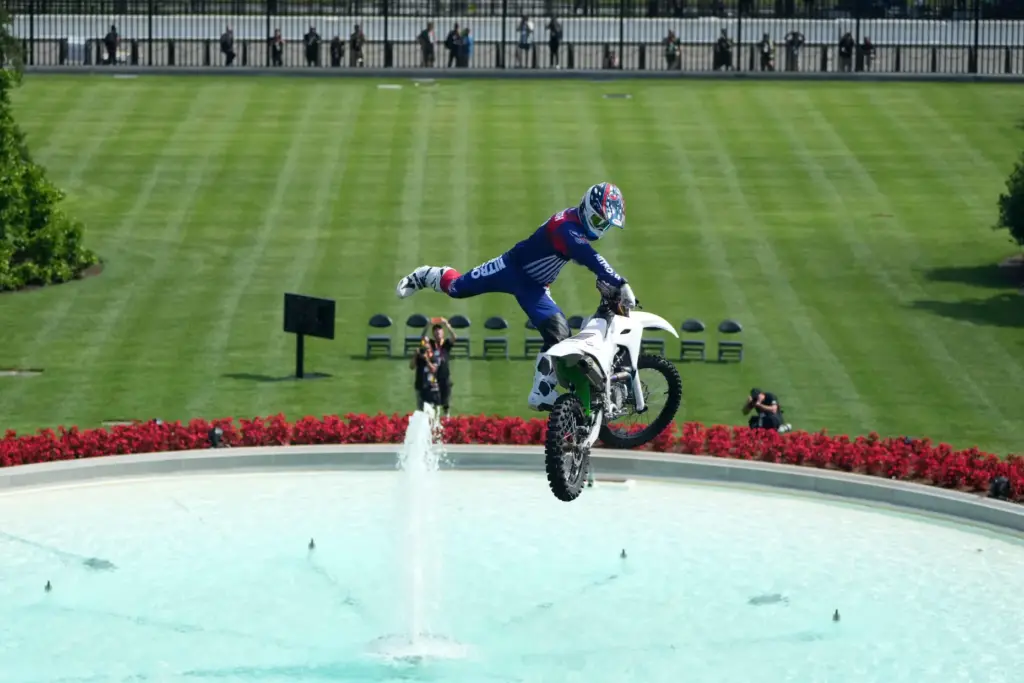 A motor sports athlete and stunt performer does a motorcycle...