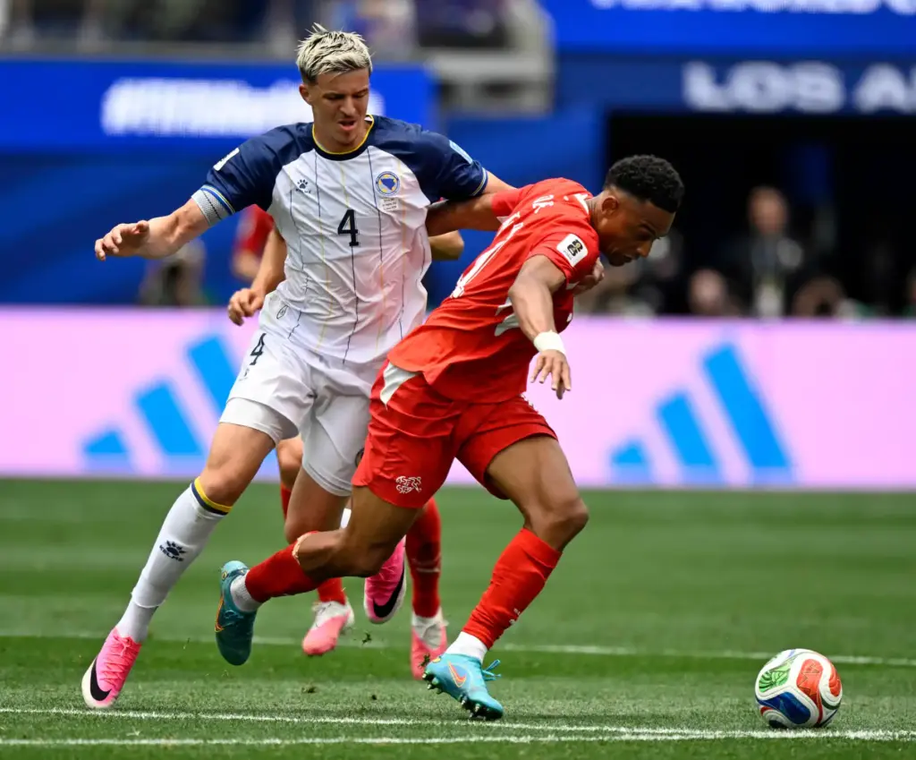 Switzerland forward Dan Ndoye (11) battles for possession with Bosnia...