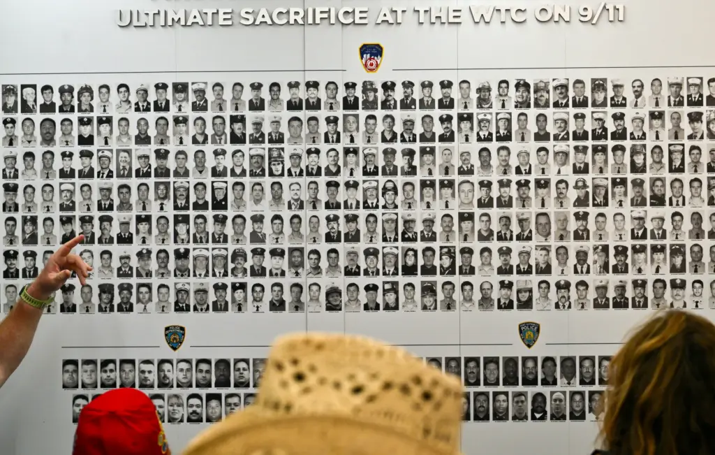 Visitors check out a memorial wall of first responders who...