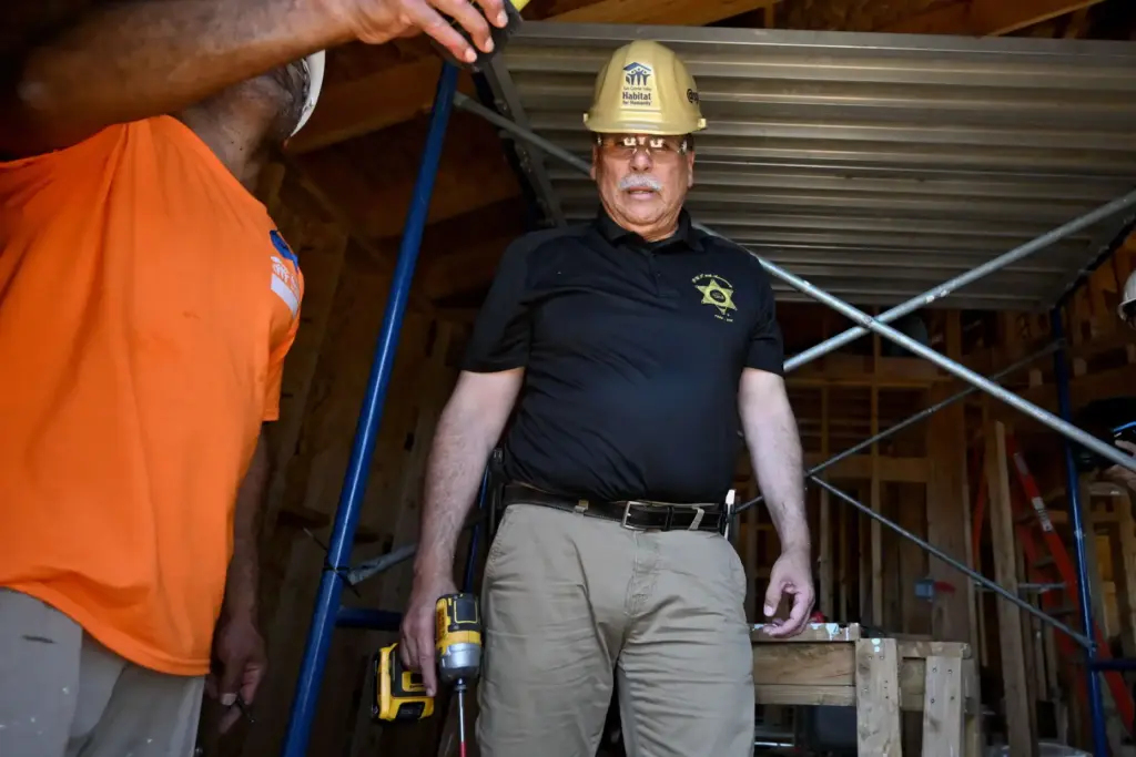 LACO Sheriff Robert Luna works with members of the Los...