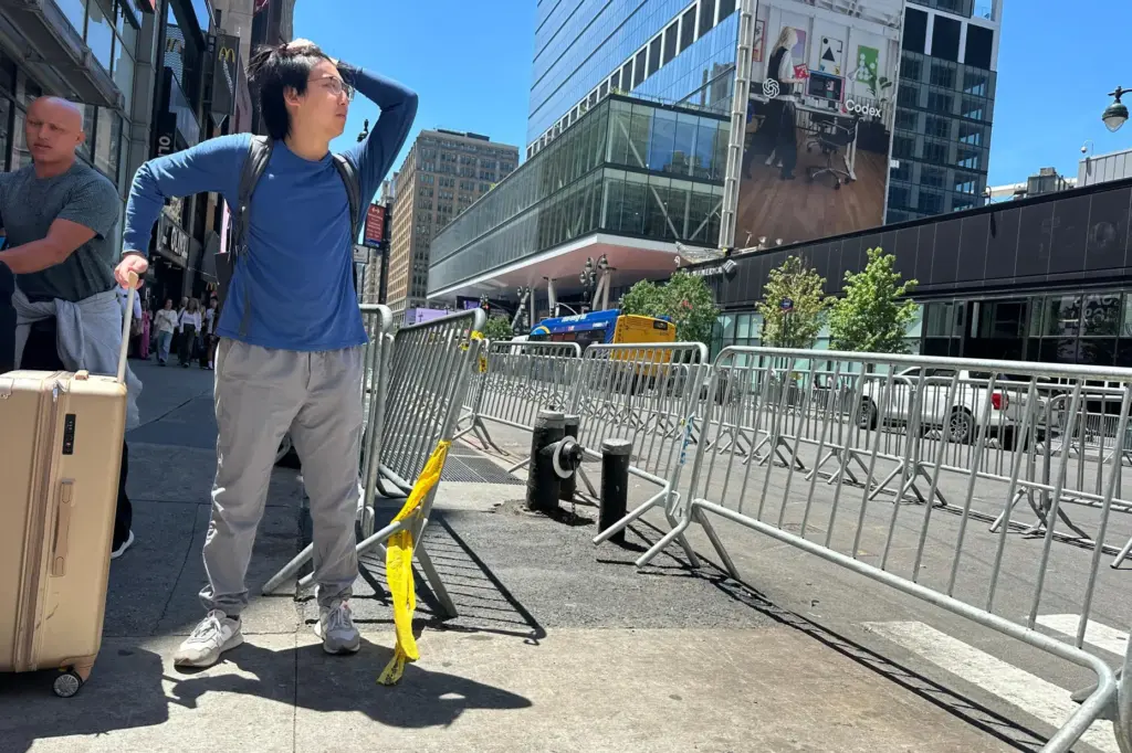 A traveler tries to navigate the area as stringent security...