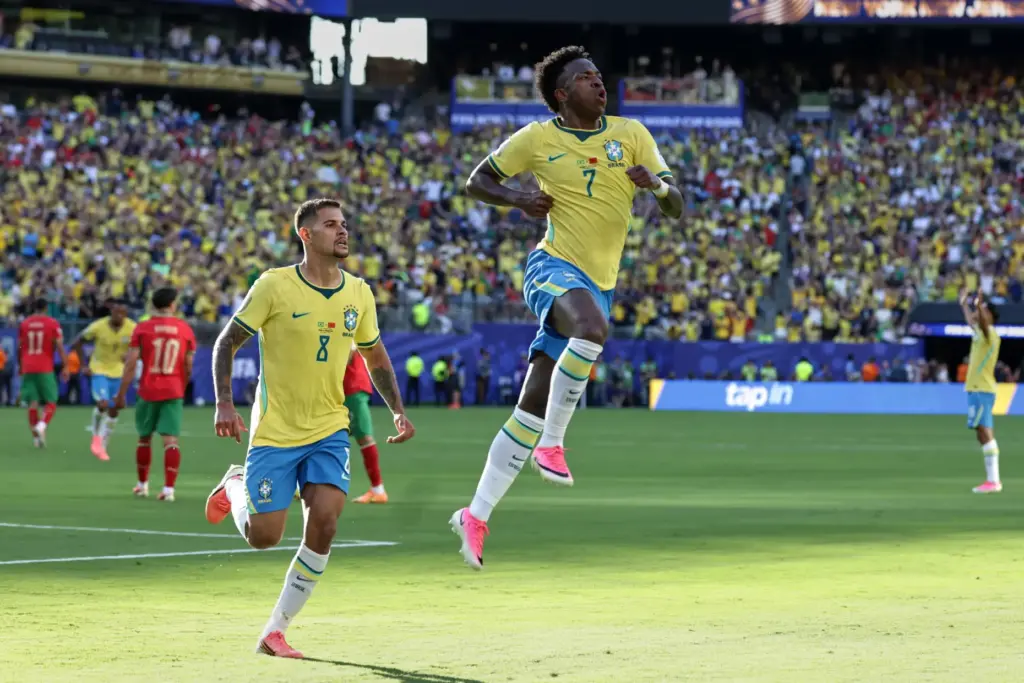 Brazil’s Vinicius Junior (7) celebrates with teammate Bruno Guimaraes (8)...