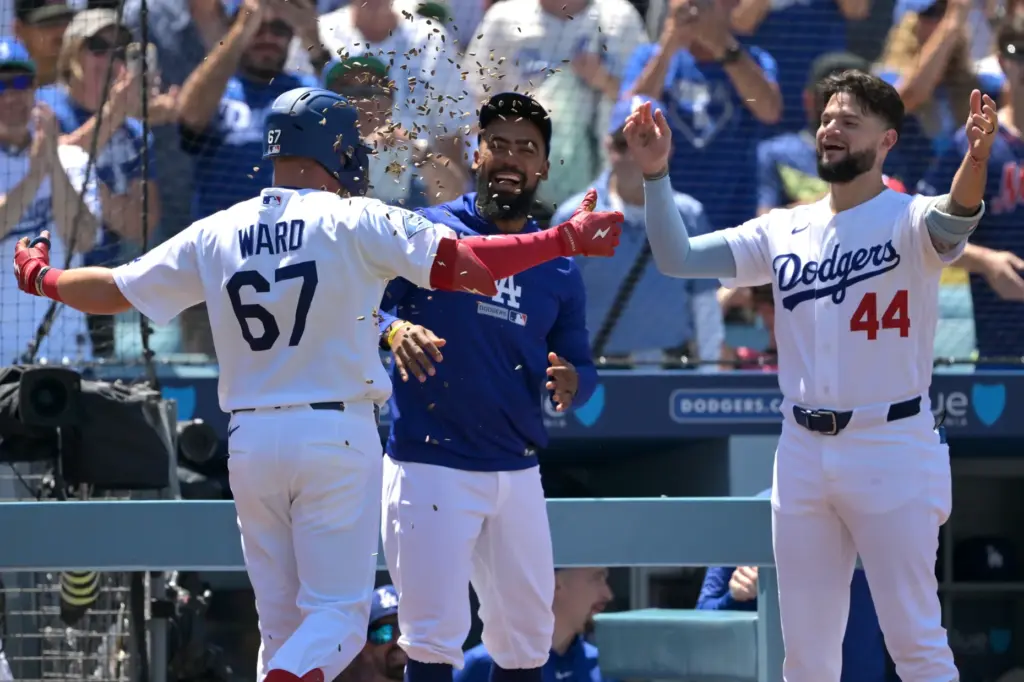 The Dodgers’ Ryan Ward, left, is congratulated by teammates Teoscar...