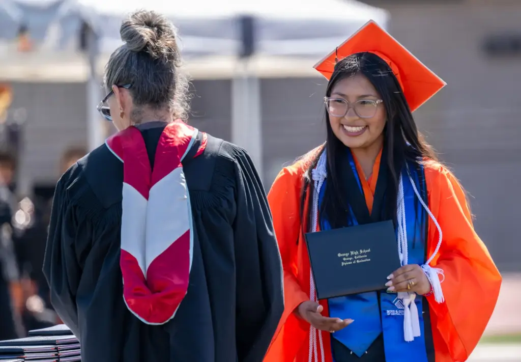 Anabel Delgado accepts her diploma during Orange High Schoolâs graduation...
