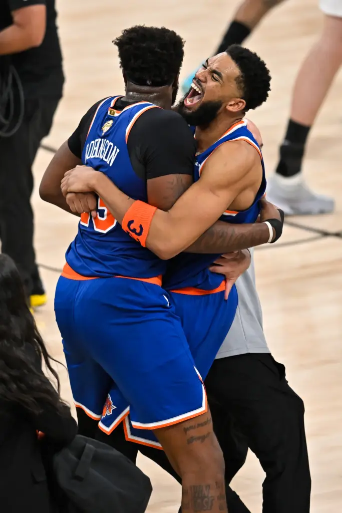 New York Knicks center Karl-Anthony Towns, right, hugs forward Og...
