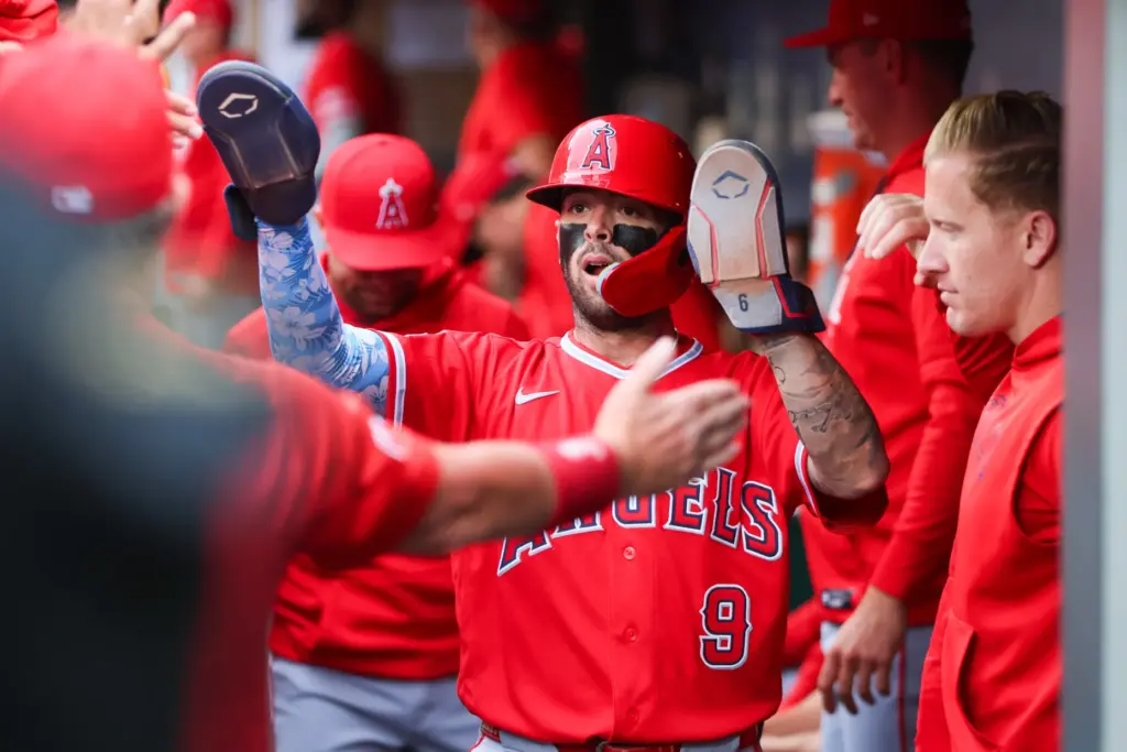 The Angels’ Zach Neto celebrates in the dugout after scoring...