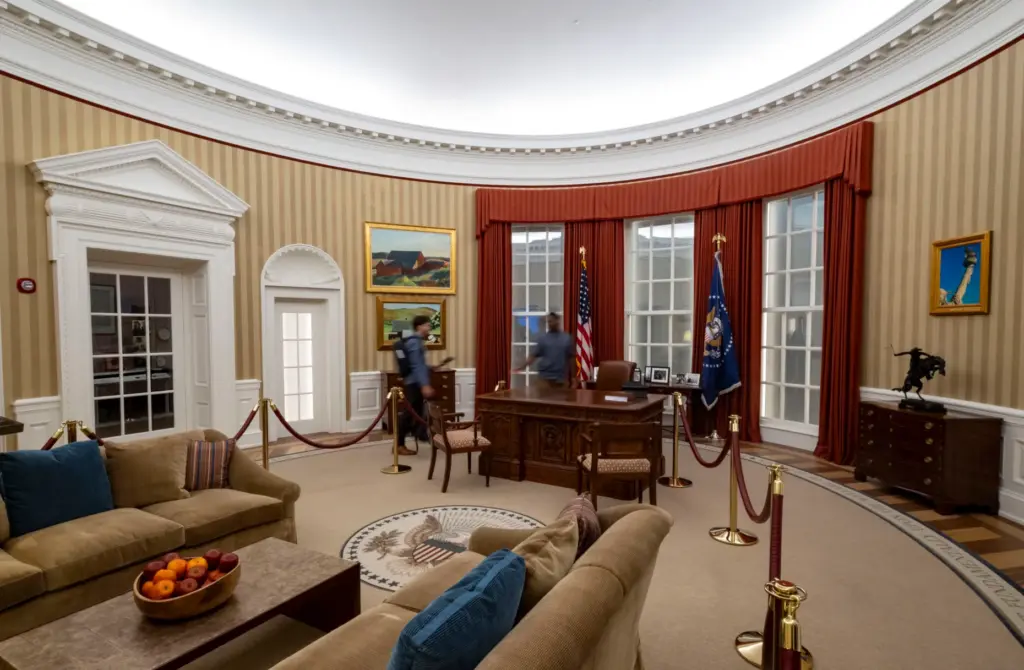 A replica of the Oval Office is on display as...