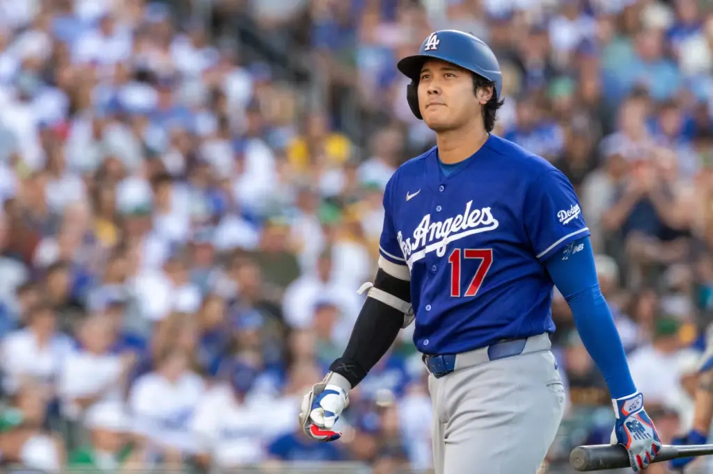 Dodgers star Shohei Ohtani walks to the dugout after striking...