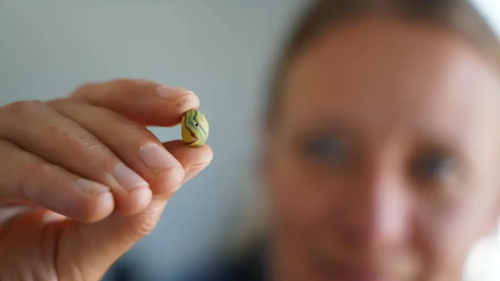 Moesgaard Museum archaeologist Liv Stidsing Reher-Langberg holds a Viking Age glass bead.