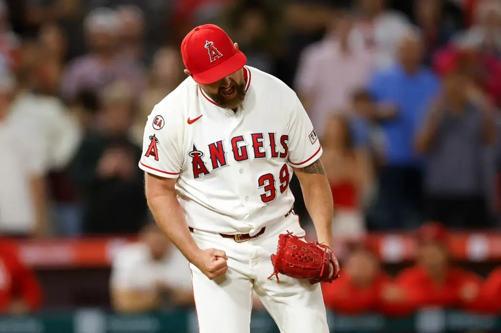 Angels relief pitcher Kirby Yates reacts after throwing out the...