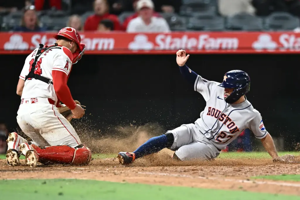 The Houston Astros’ Jose Altuve, right, scores what proved to...