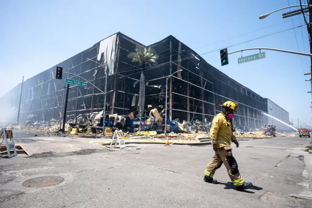 Firefighters use high-powered water canons from Texes to douse the...