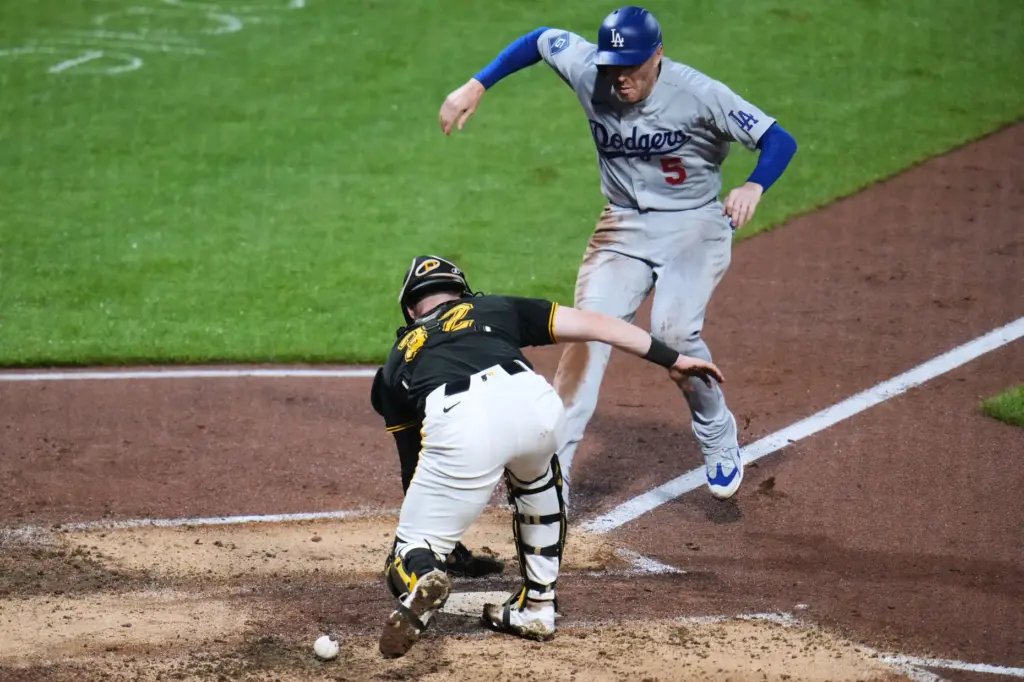 The Dodgers’ Freddie Freeman, top, scores from third base on...