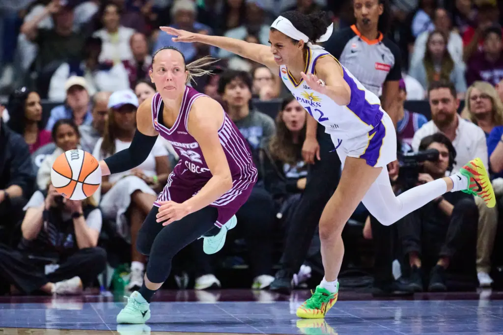 The Toronto Tempo’s Julie Allemand (22) drives past the Sparks’...