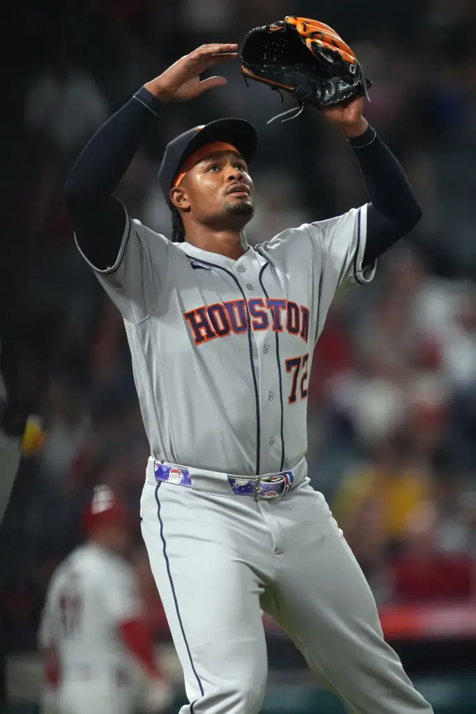 Houston Astros relief pitcher Alimber Santa gestures after retiring the...
