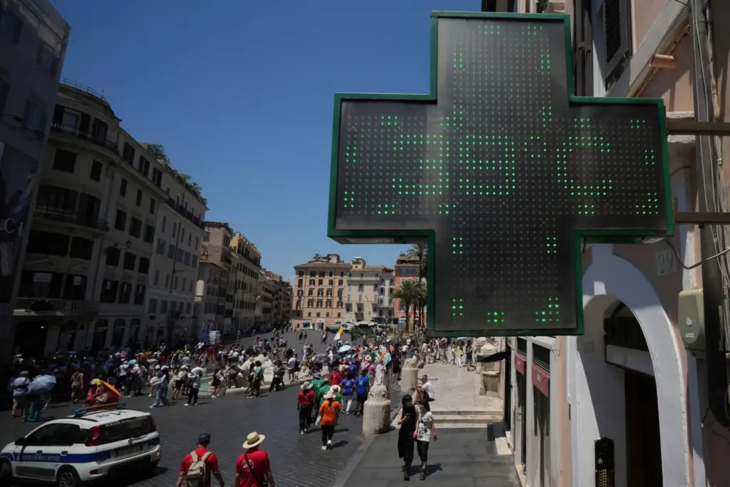 FILE – The thermometer of a drugstore shows the temperature...