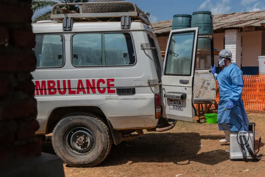 A health worker disinfects an ambulance at the Mongbwalu treatment center.