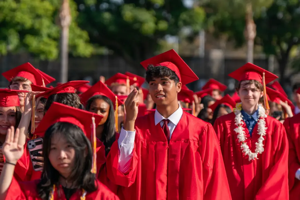 Woodbridge High School seniors sing the schoolâs alma mater during...