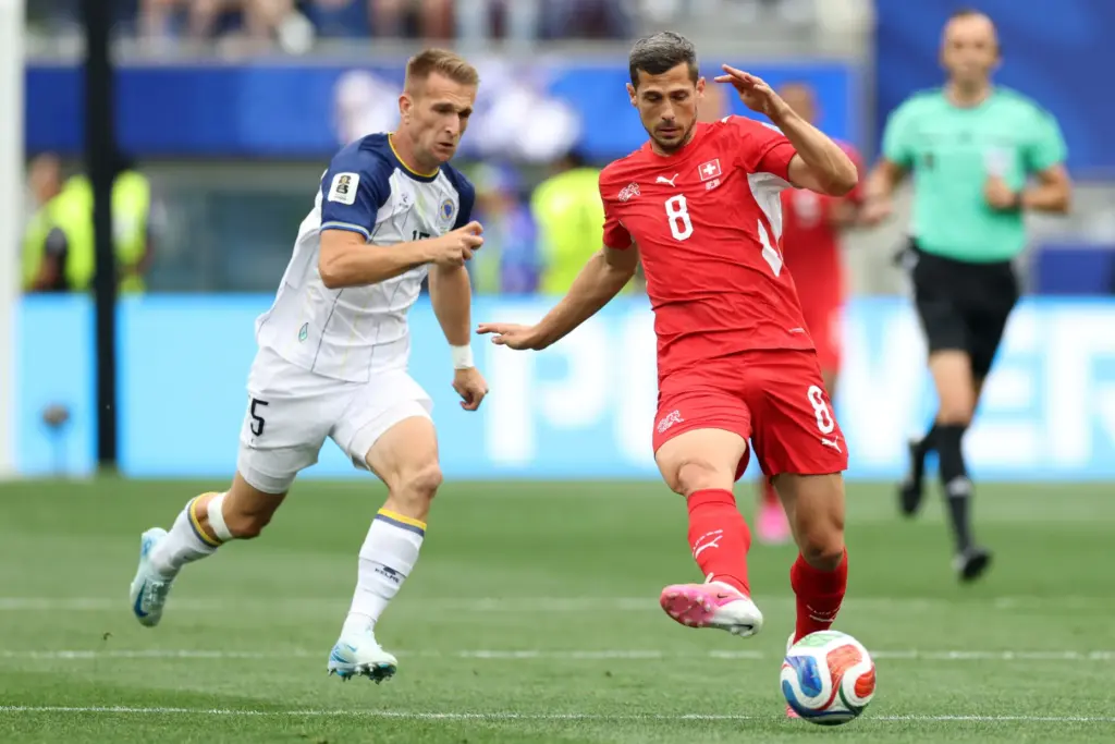Switzerland midfielder Remo Freuler (8) kicks the ball chased by...