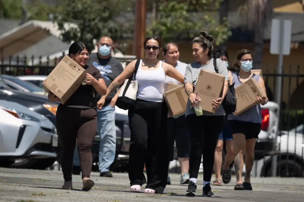 Residents affected by the Boyle Heights warehouse fire walk home...