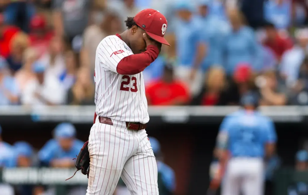 Oklahoma pitcher Xander Mercurius walks back to the dugout after...