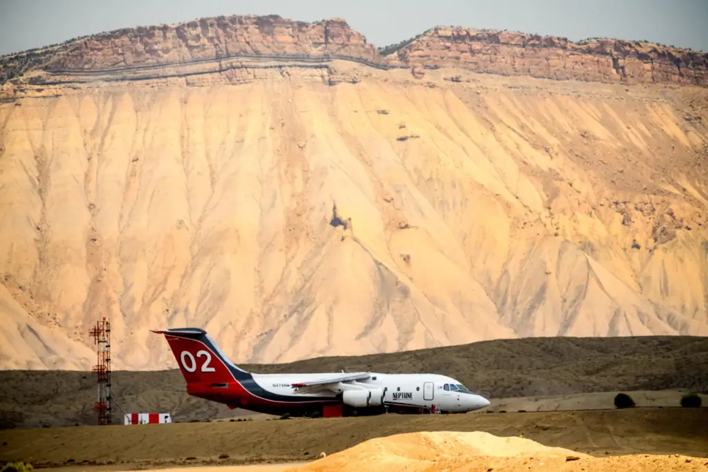 A firefighting aircraft rests on the tarmac at Grand Junction...